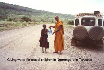 2002 Febrary giving water to a Masai child in Ngorongoro game reserve.jpg